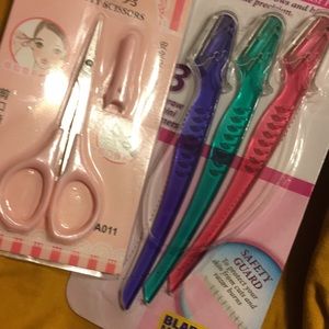 Pink eyebrow scissors and eyebrow & bikini razors